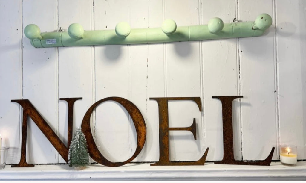 Large rusty NOEL letters